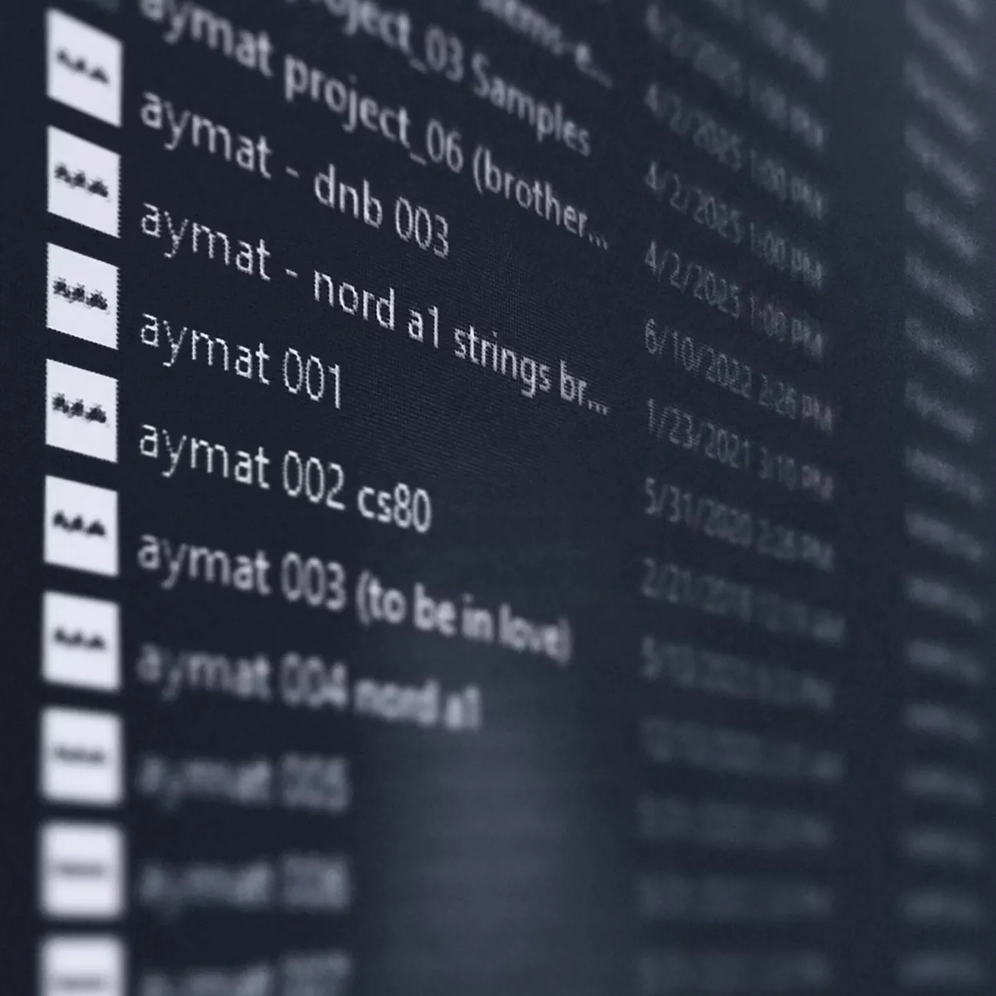 A computer screen displaying a list of audio files with names starting with "aymat" alongside dates and times. The background is blurred, creating a focused yet subdued tone.